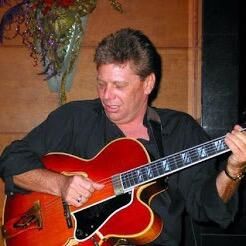 Tom Patten playing a hollow-body electric guitar